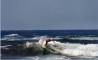 Surfeur sur la plage du Grand Capo